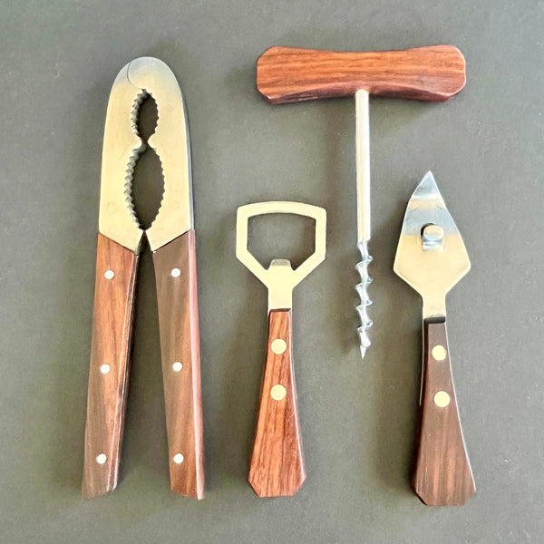 set of four rosewood handled bartools on grey background